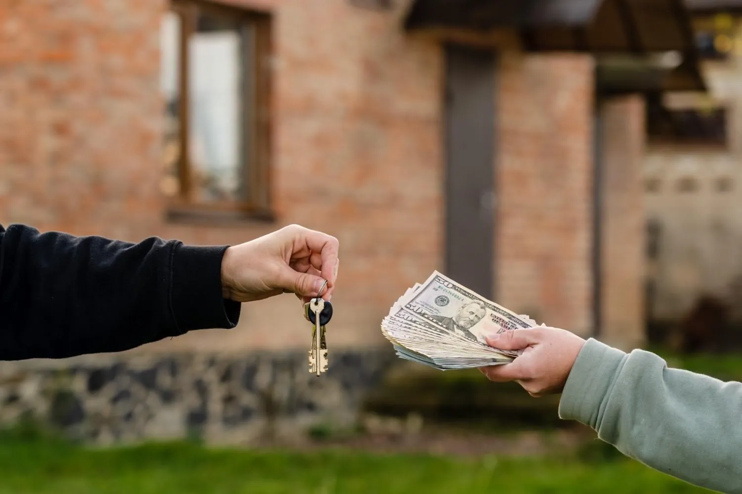 A friendly handshake over a home sale agreement